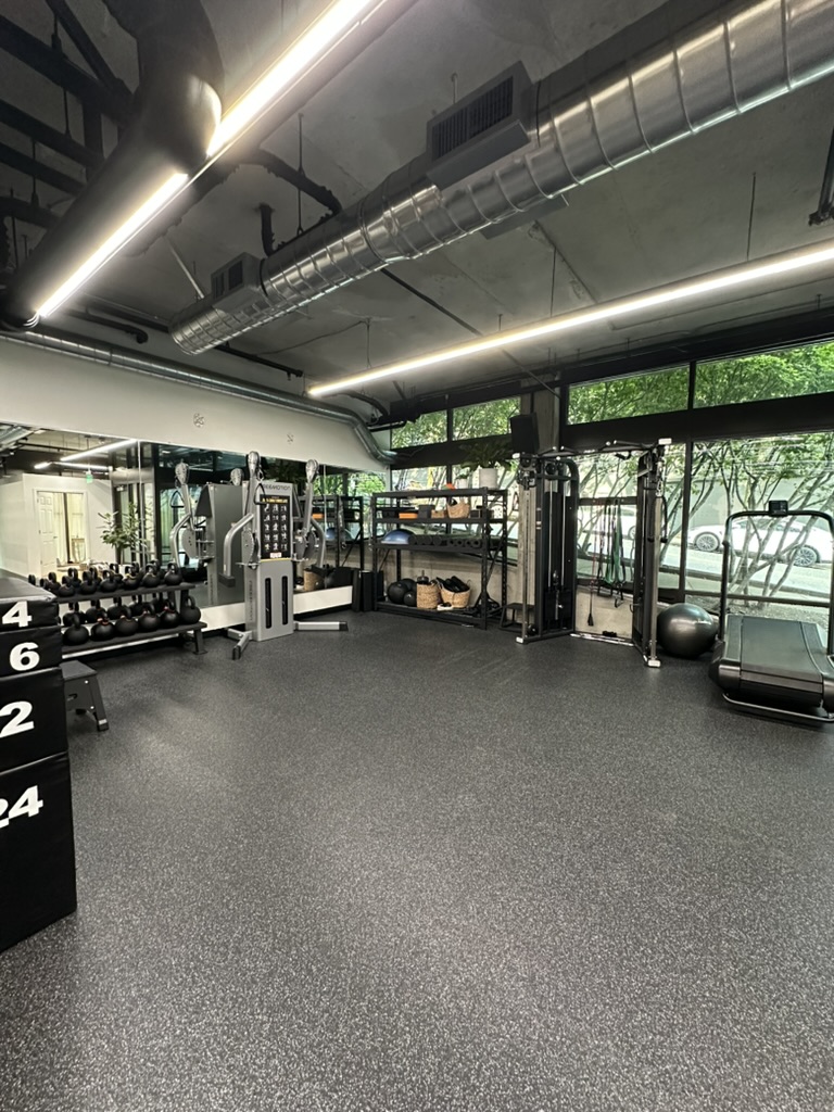Kettlebells, dumbbells and cable machines on the open training floor at the Belltown studio