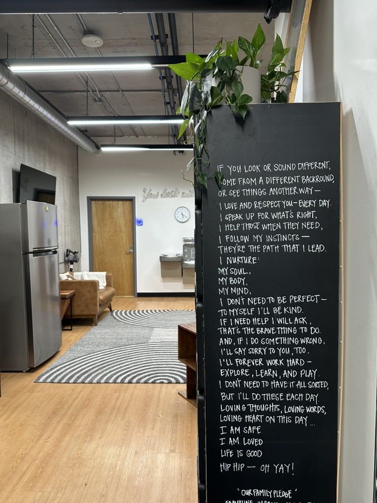 Lounge and kitchen area with a hand-lettered chalkboard at TRAIN Seattle's Independent Trainer Studio in Belltown